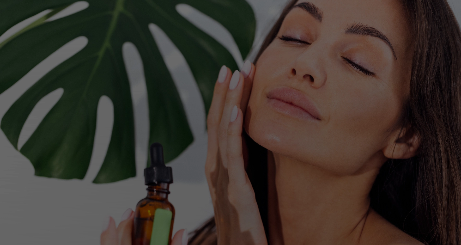 Laughing woman in a white bathrobe takes care of her skin
